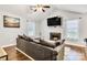 Inviting living room features a vaulted ceiling, fireplace, mounted TV, and hardwood floors at 124 Cedarcroft Dr, Mooresville, NC 28115