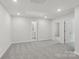 Large carpeted bedroom with ample lighting and hallway views to other rooms at 124 Utility Ln # E, Mooresville, NC 28117