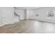 Bright living room featuring hardwood floors, staircase, and abundant natural light at 124 Utility Ln # E, Mooresville, NC 28117