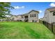 Well-maintained backyard featuring a lush lawn, a wooden deck and a sleek black fence at 12637 Belmont Mansion Dr, Charlotte, NC 28273
