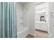 Clean bathroom featuring a tub and shower combo with white tiled walls and a neutral vanity at 12637 Belmont Mansion Dr, Charlotte, NC 28273