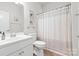 Clean, white bathroom with shower curtain and vanity with ample countertop space at 12637 Belmont Mansion Dr, Charlotte, NC 28273