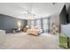 Bright bedroom boasts neutral carpet, a cozy daybed, desk, and entertainment area with a wall-mounted television at 12637 Belmont Mansion Dr, Charlotte, NC 28273