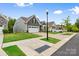 A charming curb view of a home with well-maintained lawn and sidewalks on a sunny day with blue skies at 12637 Belmont Mansion Dr, Charlotte, NC 28273