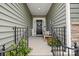 Inviting front porch features a cozy bench, potted plants, and a welcoming entrance with stylish decor at 12637 Belmont Mansion Dr, Charlotte, NC 28273