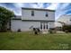 Exterior of home features a well-maintained lawn and patio with patio furniture at 12719 Walking Stick Dr, Charlotte, NC 28278