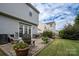 Exterior features a well-maintained backyard patio, furniture and colorful potted plants at 12719 Walking Stick Dr, Charlotte, NC 28278