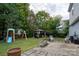 Landscaped backyard with patio, a gazebo, and a playset on a lush lawn at 12719 Walking Stick Dr, Charlotte, NC 28278