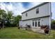Exterior of home features a well-maintained lawn and patio with patio furniture at 12719 Walking Stick Dr, Charlotte, NC 28278