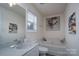 Bright bathroom with a bathtub, single vanity, and boat artwork on the wall at 12719 Walking Stick Dr, Charlotte, NC 28278