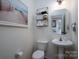 Cozy half bathroom with pedestal sink, white walls, and decor at 12719 Walking Stick Dr, Charlotte, NC 28278