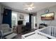 Cozy room with a crib, chair, desk and playful decorations, ideal for a learning and relaxation space at 12719 Walking Stick Dr, Charlotte, NC 28278