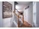 Bright entryway with wood floors, staircase, and view into the living room at 12719 Walking Stick Dr, Charlotte, NC 28278