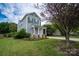 Charming two-story home with a covered front porch and well-manicured lawn at 12719 Walking Stick Dr, Charlotte, NC 28278