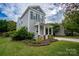 Well-maintained home showcasing charming curb appeal with meticulous landscaping and inviting porch at 12719 Walking Stick Dr, Charlotte, NC 28278