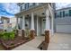Inviting front porch featuring classic columns, decorative brick accents, and a 'Welcome' sign at 12719 Walking Stick Dr, Charlotte, NC 28278