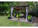 Backyard gazebo on brick base with furniture and elegant privacy curtains at 12719 Walking Stick Dr, Charlotte, NC 28278