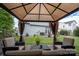 Cozy backyard gazebo with furniture and privacy curtains and view of backyard at 12719 Walking Stick Dr, Charlotte, NC 28278