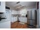 Bright kitchen features white cabinets, stainless steel appliances, and hardwood floors at 12719 Walking Stick Dr, Charlotte, NC 28278