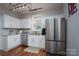 Bright kitchen features white cabinets, stainless steel appliances, and hardwood floors at 12719 Walking Stick Dr, Charlotte, NC 28278