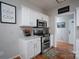 Bright kitchen featuring stainless steel appliances, white cabinets, and wood flooring at 12719 Walking Stick Dr, Charlotte, NC 28278