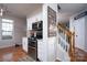 View of modern appliances with the stairwell nearby at 12719 Walking Stick Dr, Charlotte, NC 28278