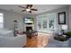Living room with hardwood floors, fireplace, and French doors at 12719 Walking Stick Dr, Charlotte, NC 28278