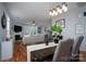 Open living room and dining area featuring hardwood floors and a fireplace at 12719 Walking Stick Dr, Charlotte, NC 28278