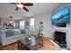 Living room with hardwood floors, fireplace, and a ceiling fan at 12719 Walking Stick Dr, Charlotte, NC 28278