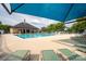 Beautiful community pool featuring spacious pool deck, sun loungers, and shaded area at 12719 Walking Stick Dr, Charlotte, NC 28278