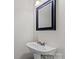 Small bathroom with white sink and ornate bronze faucet at 128 Locomotive Ln, Mooresville, NC 28115