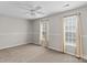 Light bedroom with neutral carpet, white curtains, and a ceiling fan at 128 Locomotive Ln, Mooresville, NC 28115