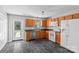 Well-lit kitchen features wood cabinets, stainless steel dishwasher, and a door leading to the outside at 128 Locomotive Ln, Mooresville, NC 28115