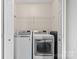 Laundry room with front loading washer and dryer, wire shelf, and white walls at 128 Locomotive Ln, Mooresville, NC 28115