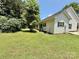 The backyard features a lush green lawn, mature trees, and the exterior of the home with visible AC units at 1657 Diary Dr, Rock Hill, SC 29730
