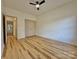 Bedroom with hardwood floors, a ceiling fan, a closet, and an adjacent doorway leading to another room at 1657 Diary Dr, Rock Hill, SC 29730