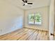 A bright bedroom featuring a ceiling fan, hardwood floors, and a window with a view of the outdoors at 1657 Diary Dr, Rock Hill, SC 29730