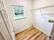 Laundry room with hardwood floors, window, and wire shelf at 1657 Diary Dr, Rock Hill, SC 29730