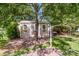 Backyard shed, carport, and lawn-care equipment tucked under shade trees at 2078 Valley View Ln, Lincolnton, NC 28092