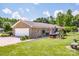 Rear view with a two-car garage and a relaxing backyard hot tub at 2078 Valley View Ln, Lincolnton, NC 28092