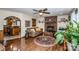 Inviting living room with hardwood floors, brick fireplace, open access to kitchen and a decorative ceiling fan at 2078 Valley View Ln, Lincolnton, NC 28092
