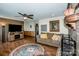 Comfortable living room area with a brick fireplace, wood-look flooring, and a decorative ceiling fan at 2078 Valley View Ln, Lincolnton, NC 28092