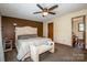 Bedroom with accent wall, ceiling fan, neutral carpet, and ensuite bathroom at 2078 Valley View Ln, Lincolnton, NC 28092
