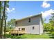 View of backyard featuring a new gray siding home, wooden deck, and lovely green space at 2313 Stallings Rd, Harrisburg, NC 28075