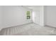 Bedroom with carpet, closet, double doors and window with natural light at 2313 Stallings Rd, Harrisburg, NC 28075