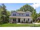 Beautiful two-story home with manicured lawn, stone accents, and a welcoming front porch at 2313 Stallings Rd, Harrisburg, NC 28075