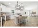 Bright kitchen with white cabinets, stainless steel appliances, and a functional center island at 2313 Stallings Rd, Harrisburg, NC 28075