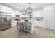 Modern kitchen features white cabinetry, stainless steel appliances, and a center island at 2313 Stallings Rd, Harrisburg, NC 28075