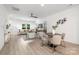 Open-concept living area with wood floors, stylish furnishings, and seamless flow into dining space at 2313 Stallings Rd, Harrisburg, NC 28075