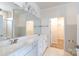 Bright bathroom with dual sink vanity, large mirror and white trim at 238 Cherrytree Dr, Fort Mill, SC 29715